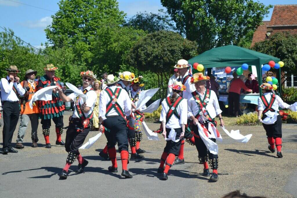 Traditional Morris dancing: vibrant costumes, rhythmic steps, and festive spirit.